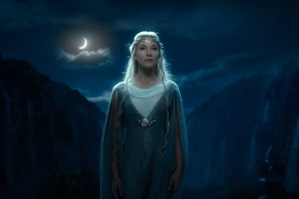 A woman from the movie on the background of a waterfall and a moon