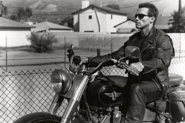 Arnold Schwarzenegger rides a motorcycle