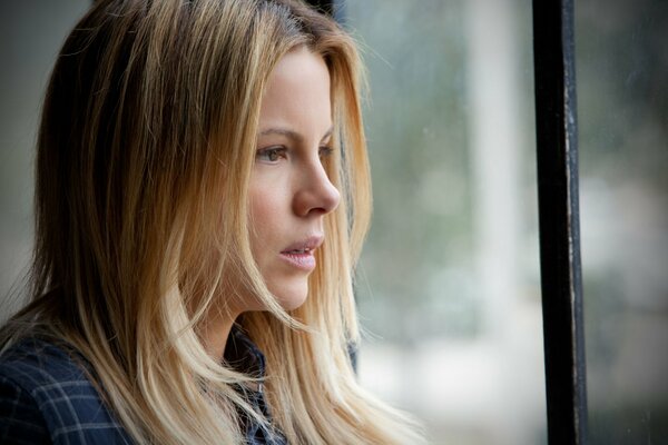 La chica Mira por la ventana. Kate Beckinsale