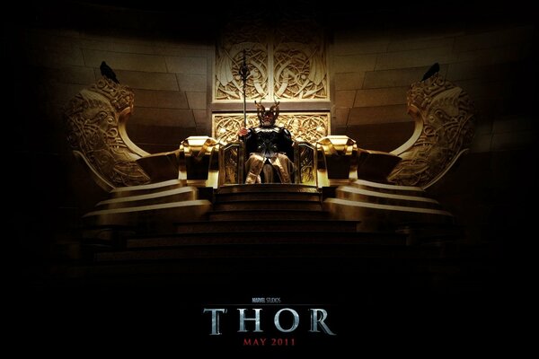 Poster of the blockbuster movie Thor, the god sitting on the throne of Asgard in festive attire and with regalia