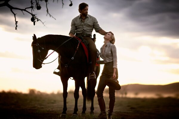 A couple admires each other at sunset