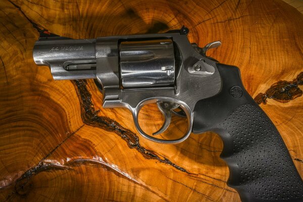 Black revolver on a wooden background