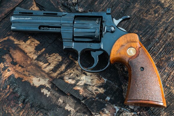 A black revolver with a brown handle