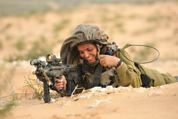 Israeli girl soldier with a gun in her hands