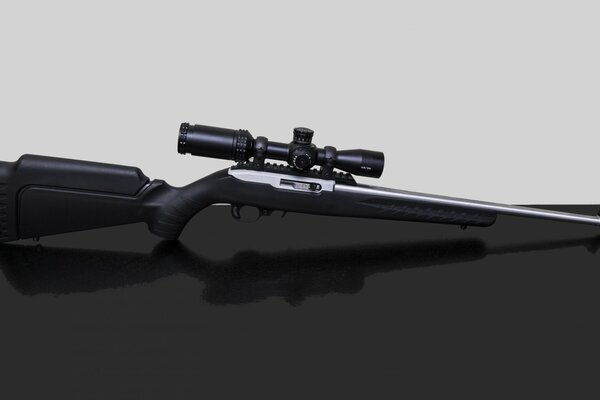 Sniper rifle on a black surface