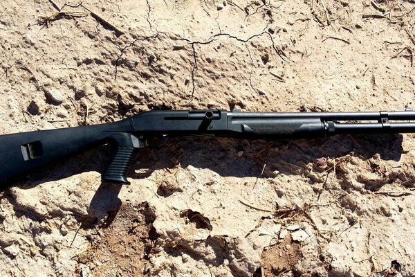 Smoothbore Benelli M1 weapon on cracked ground