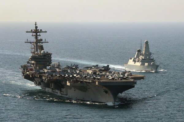 The Uss George Bush of incredible size cuts through the waves of the sea