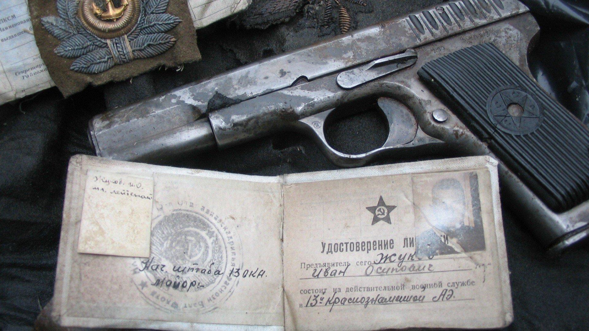 things shot down soviet pilot found in a peat bog photo taken on his tunic pistol documents star soviet union russia zhukov ivan osipovich