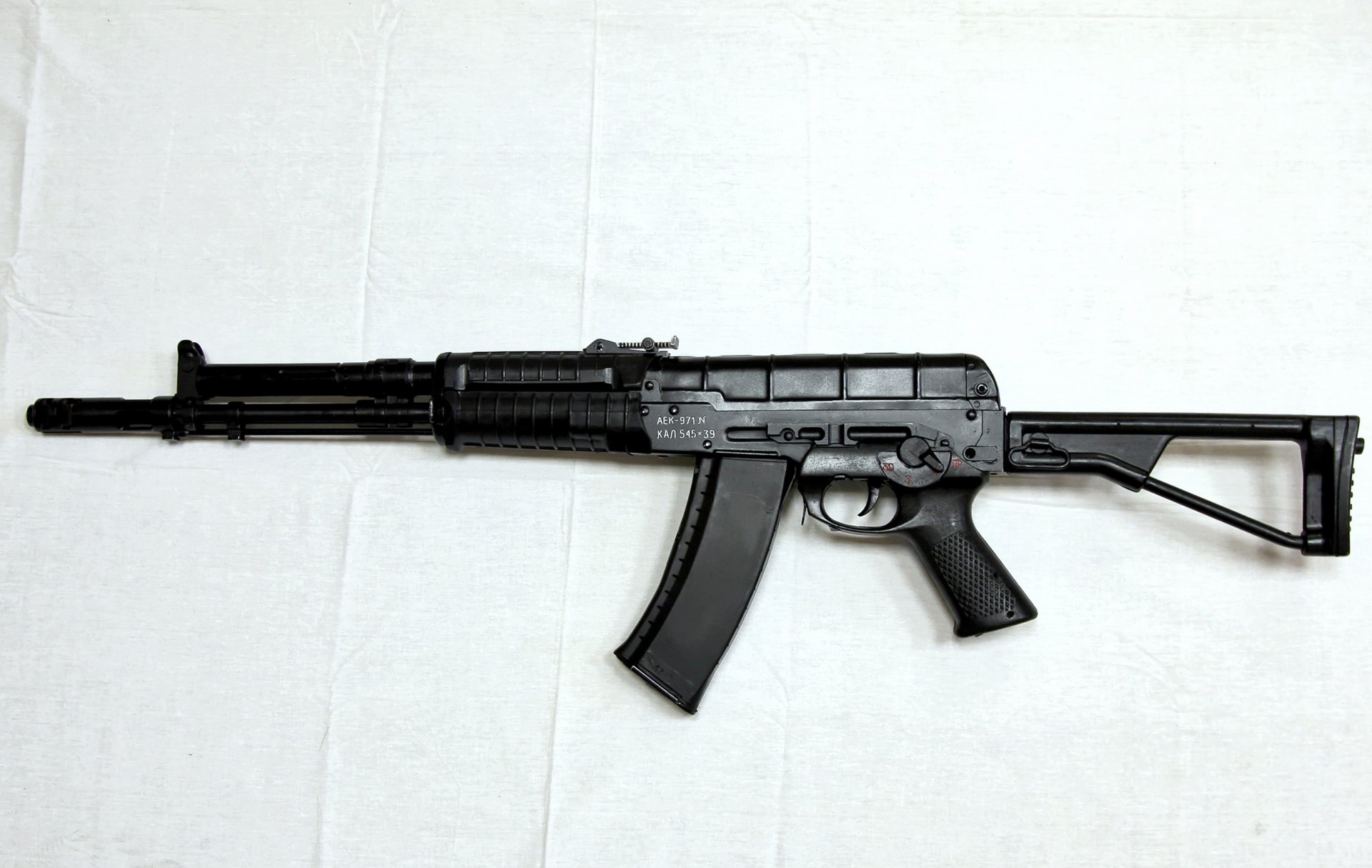 aek-971 view left domestic automatic under cartridge 5.45x39 index grau 6p67 developed in 1978 year at factory named after degtyarev barrel butt magazine muzzle brake compensator ramrod sighting device background shadow light force