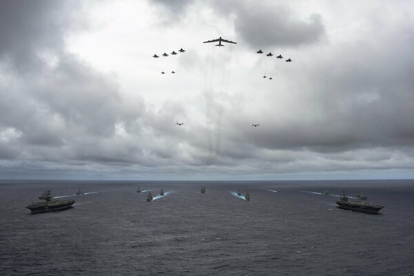 Una manada de aviones vuela sobre buques de guerra