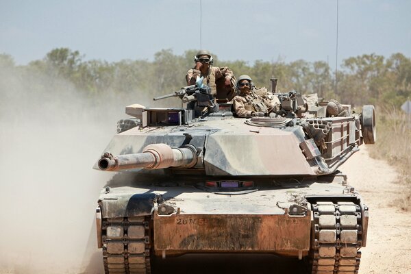 Soldiers pose sitting on a tank