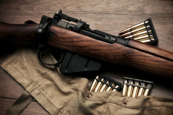 Vintage rifle with cartridges on the equipment bag