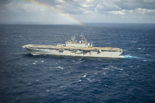Landing ship at sea on a rainbow background