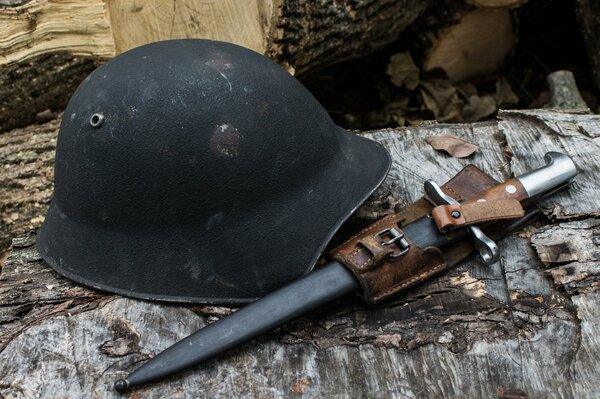 Bayonet-knife next to an infantry helmet