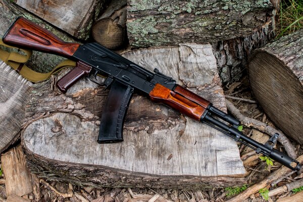 A Kalashnikov assault rifle is lying on a block