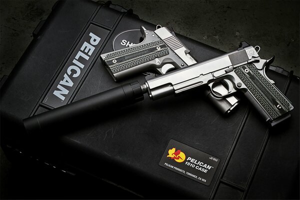 Pistol with a silencer on a black background