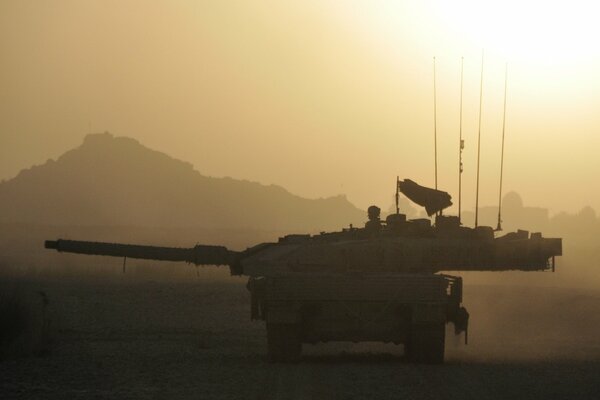 Tank on the background of misty mountains mountains