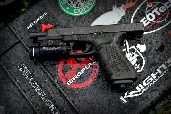 A self-loading Glock pistol. Raindrops