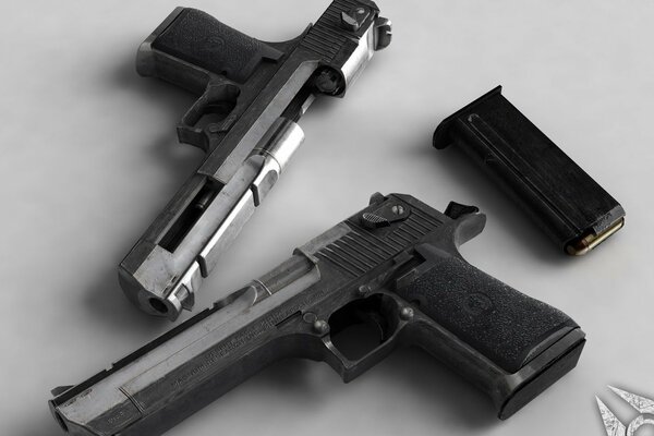 Two pistols are lying on a white background and a clip