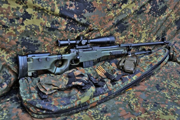 Sniper rifle on camouflage camouflage clothing, full arsenal