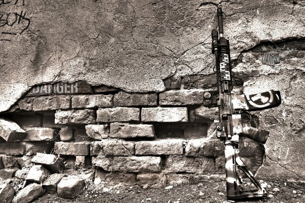 Machine gun on the background of a destroyed brick wall