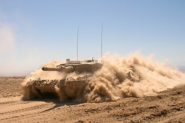 Battle tank in the dust of the desert