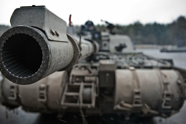 The black muzzle of a battle tank