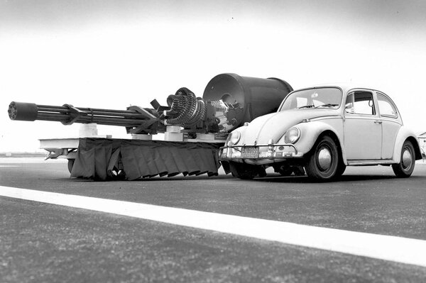 Volkswagen Beetle, al lado de un cañón de aviación