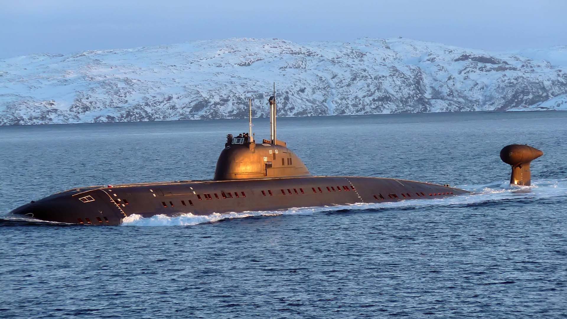 fleet submarine boat in ocean distant snowy mountains