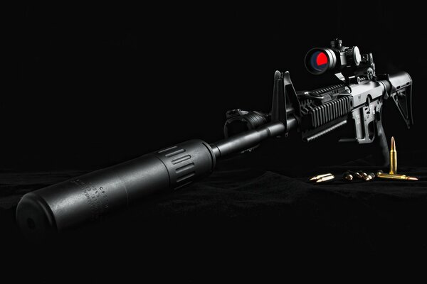 Rifle with optics and silencer on black velvet