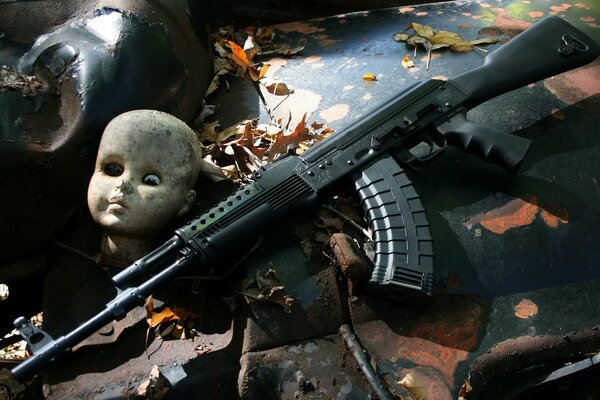 A machine gun and the head of an old toy doll