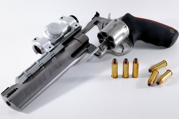 Photo of a revolver with cartridges on a white background