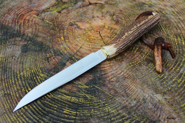 Długi nóż z rękojeścią z rogu ze skórzanym paskiem