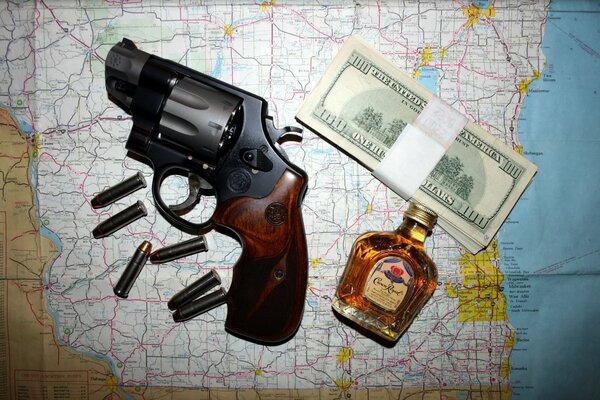 Cognac, money and revolver on the map