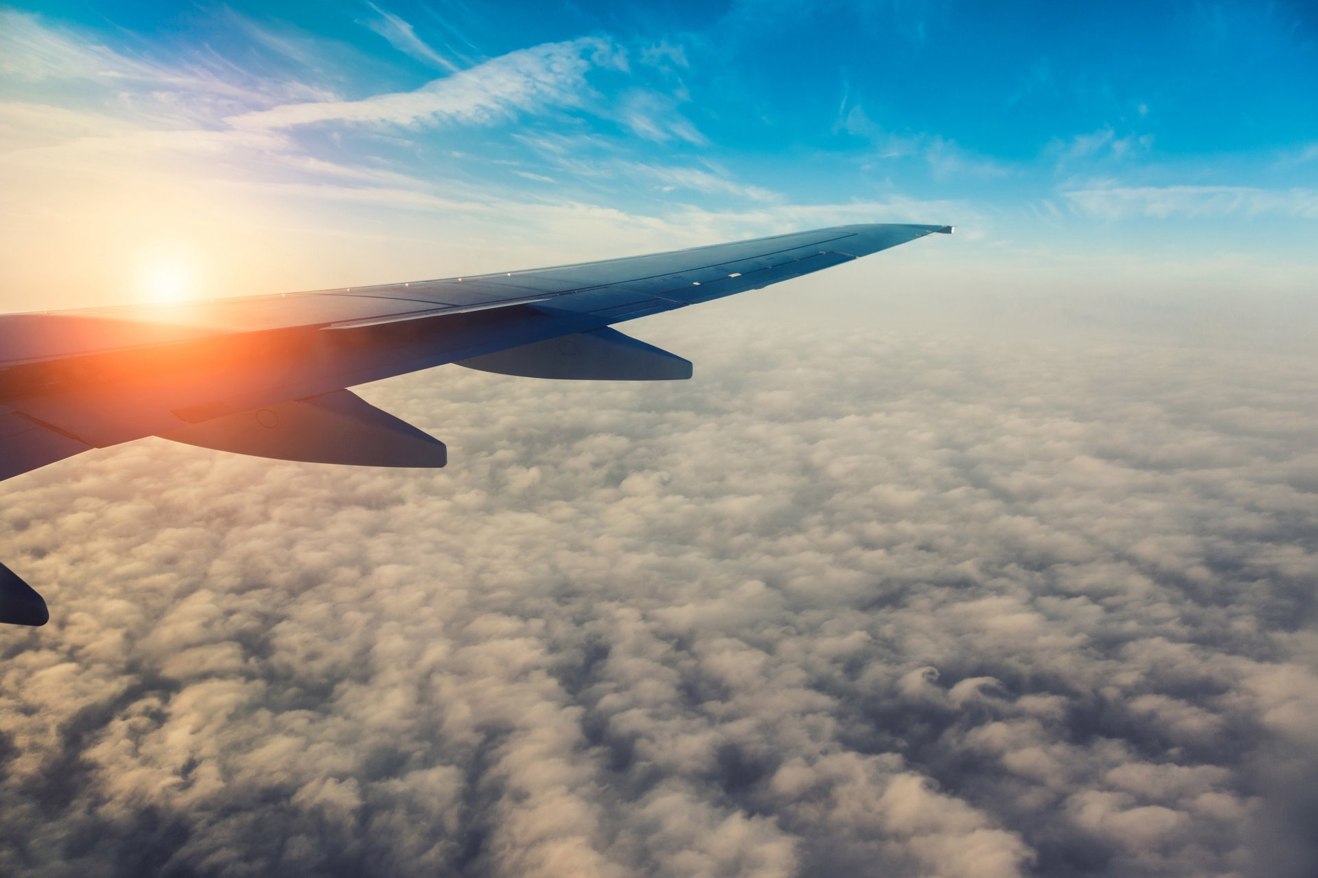 airplane airliner passenger sky cumulus clouds flight wing morning bright sun beautiful background blur bokeh wallpaper