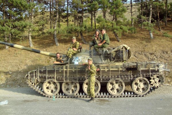 Russian soldiers with a tank on the road