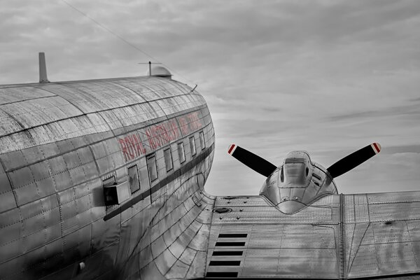 Douglas C-47 aircraft on the ground against a gray sky