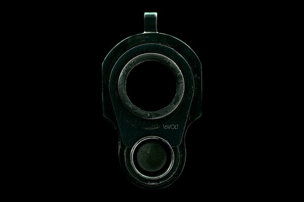 The muzzle of a weapon on a black background