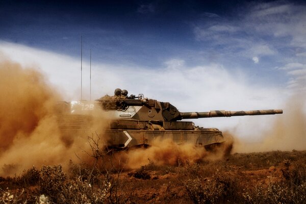 Clouds of red dust are raised by a roaring tank rushing across the field