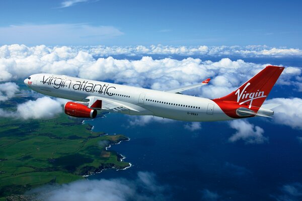 Passenger plane on the background of clouds and the sea