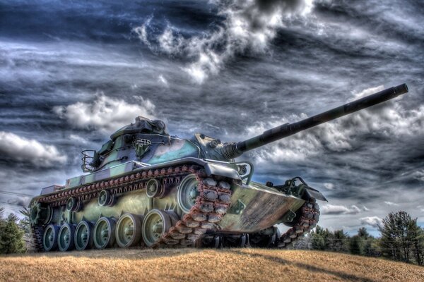 Tank in the field against the sky