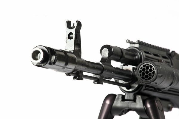 The barrel of a machine gun with a sight on a white background