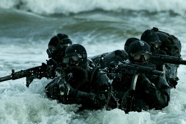 Группа морского спецназа в море с оружием автомат