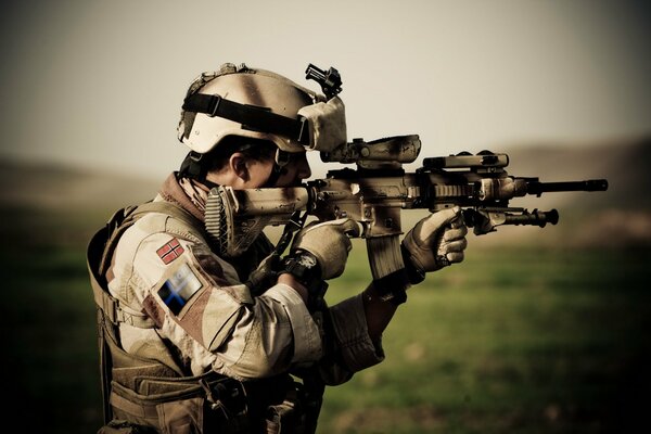 A soldier aims a gun at a target