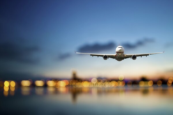 Passenger plane in the sky against the background of city lights