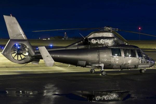 The helicopter to Dauphin 2 is standing on a wet platform