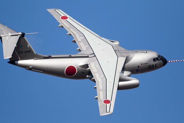 Двухмоторный военно-траспортный самолёт kawasaki на фоне безоблачного неба