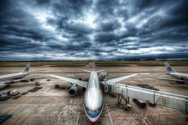 Avión de pasajeros en el aeropuerto en medio de un cielo tormentoso