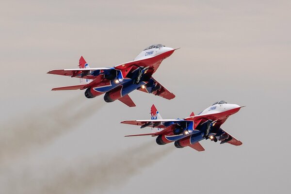 A pair of fighter jets in flight on the background