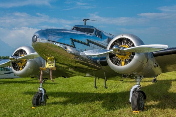 A plane against a clear sky on the grass